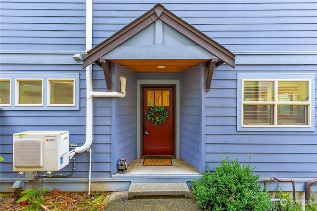 doorway to property with ac unit