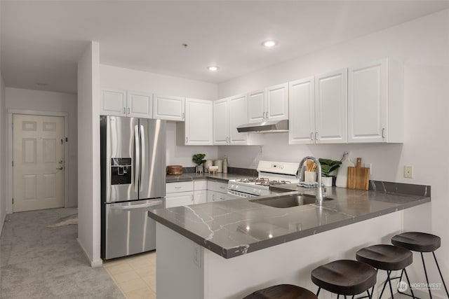 kitchen featuring stainless steel fridge with ice dispenser, white cabinets, kitchen peninsula, and white gas stove