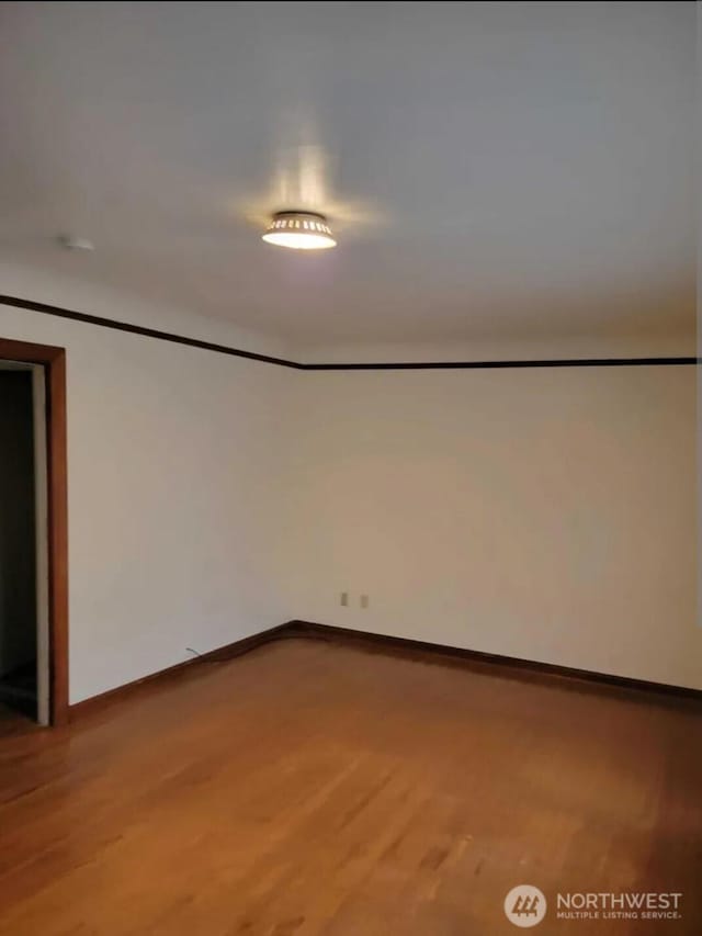 unfurnished room featuring hardwood / wood-style floors