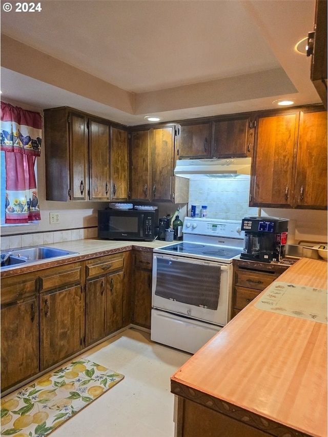 kitchen featuring electric stove and dark brown cabinetry