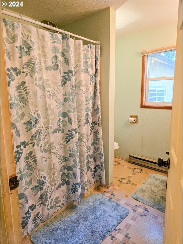 bathroom with a shower with curtain, a textured ceiling, baseboard heating, and toilet