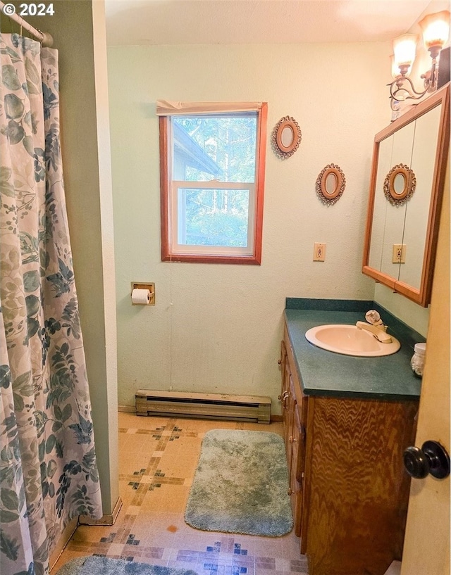 bathroom featuring baseboard heating, vanity, a chandelier, and curtained shower