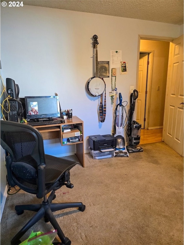 office featuring a textured ceiling and carpet