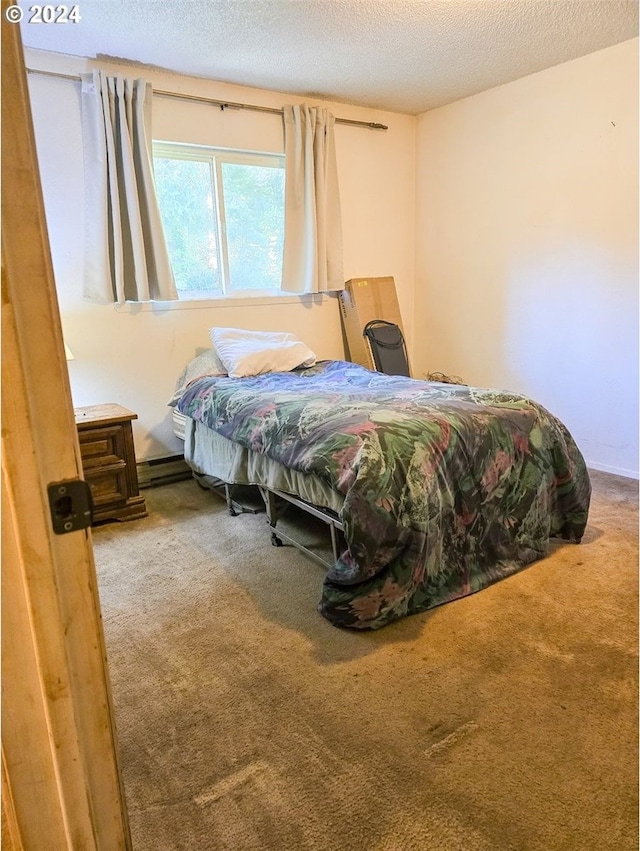 bedroom with a textured ceiling and carpet