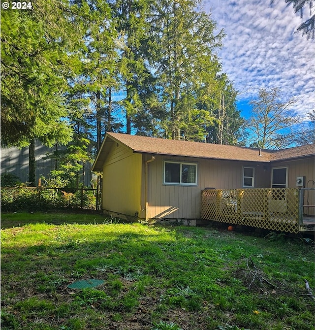 rear view of house featuring a yard