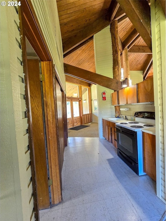 kitchen featuring sink, wood walls, wood ceiling, high vaulted ceiling, and black range with electric cooktop