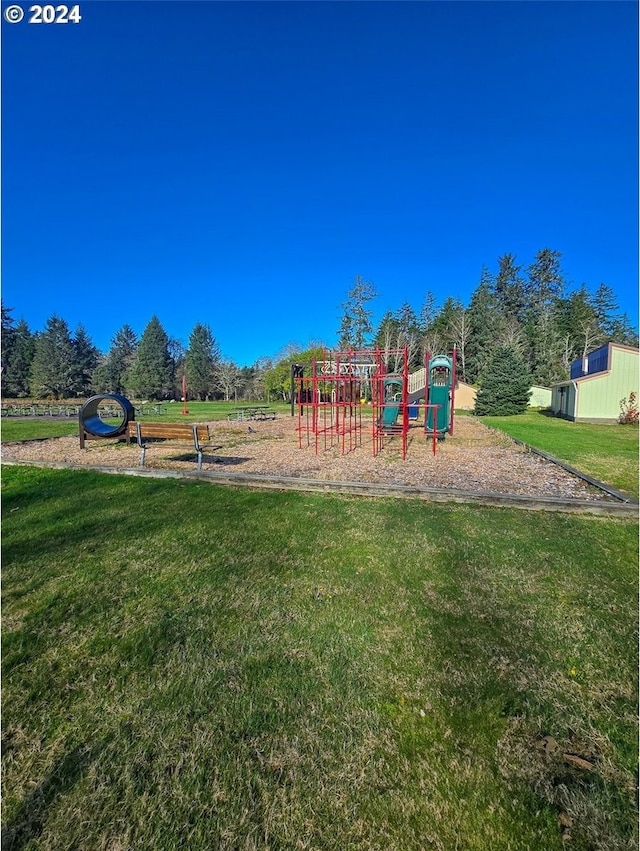 view of playground with a lawn