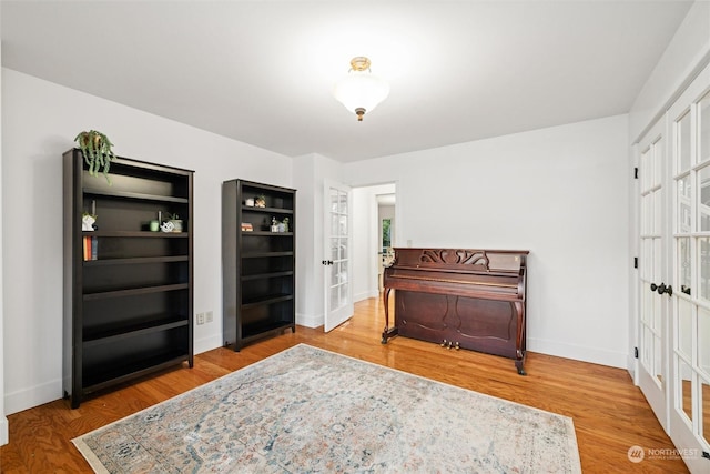 sitting room featuring hardwood / wood-style floors and french doors