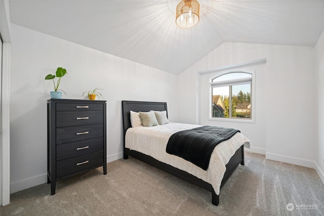 bedroom with lofted ceiling and light carpet