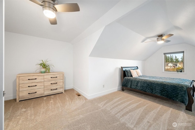 bedroom with vaulted ceiling, light colored carpet, and ceiling fan