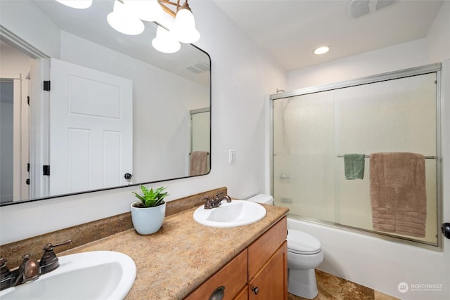 full bathroom featuring vanity, enclosed tub / shower combo, toilet, and an inviting chandelier