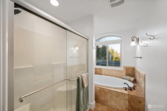 bathroom featuring separate shower and tub