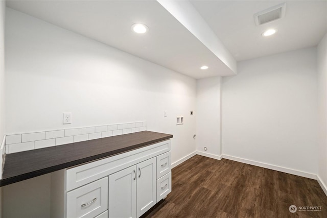 laundry area with dark wood-type flooring, hookup for a washing machine, cabinets, hookup for a gas dryer, and hookup for an electric dryer