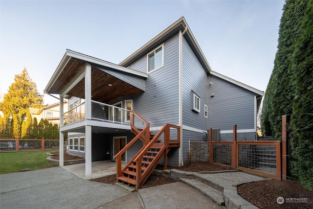 back of property with a balcony and a patio area