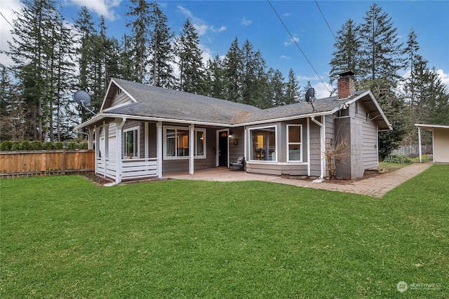 rear view of house featuring a yard and a patio area