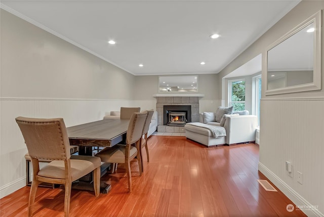 dining area featuring hardwood / wood-style flooring and crown molding