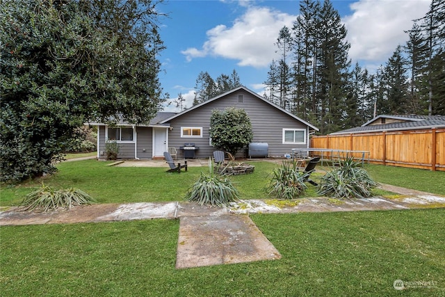 back of property featuring a yard and a patio