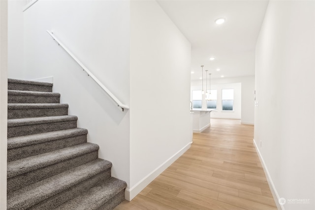 stairs featuring wood-type flooring