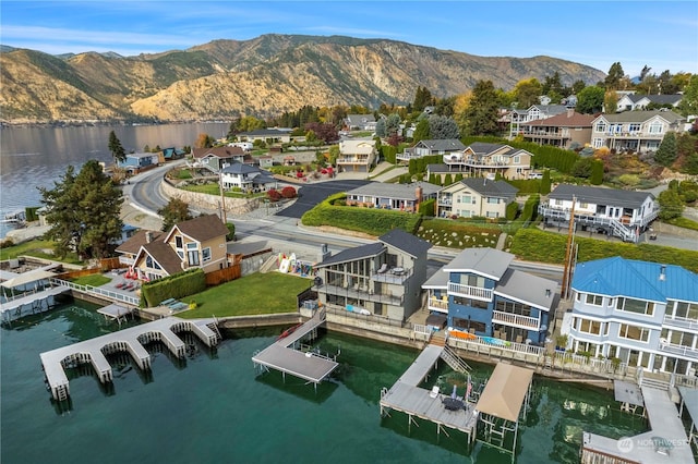 drone / aerial view with a water and mountain view