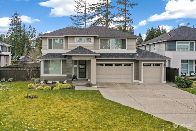 view of front of property with a garage and a front lawn