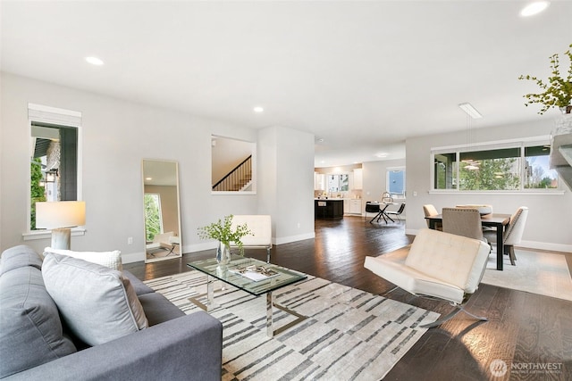 living room with a wealth of natural light, wood finished floors, and recessed lighting