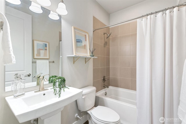 bathroom featuring shower / tub combo, a sink, and toilet