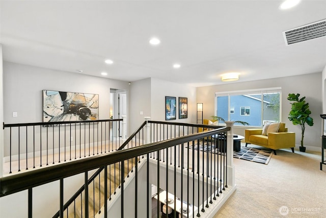 corridor with carpet floors, recessed lighting, visible vents, an upstairs landing, and baseboards