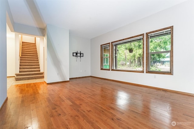 unfurnished living room with light hardwood / wood-style flooring