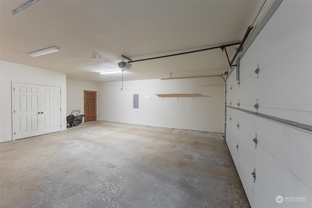 garage with a garage door opener and electric panel