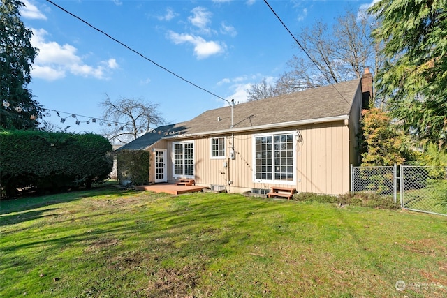 back of property featuring a lawn