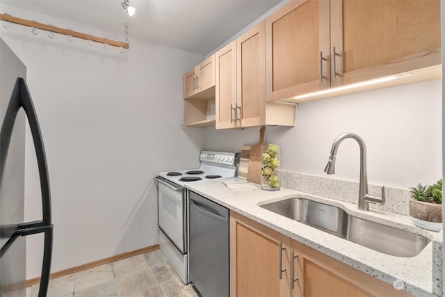 kitchen with sink, white electric range, black refrigerator, light stone countertops, and stainless steel dishwasher