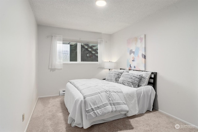 bedroom with light colored carpet and a textured ceiling