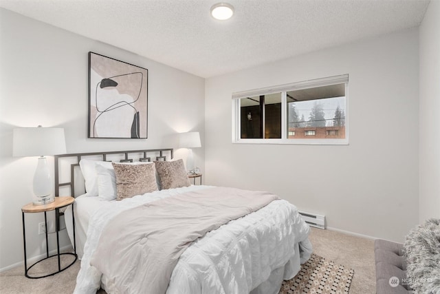 bedroom featuring light colored carpet, a textured ceiling, and a baseboard heating unit