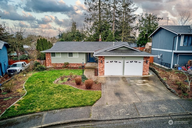 view of front of house with a garage and a front lawn