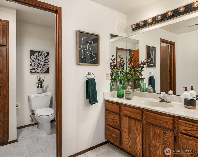 bathroom with visible vents, baseboards, toilet, tile patterned floors, and vanity