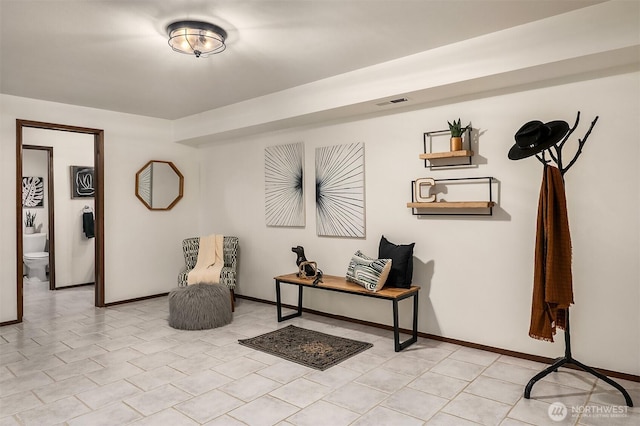 living area featuring visible vents and baseboards