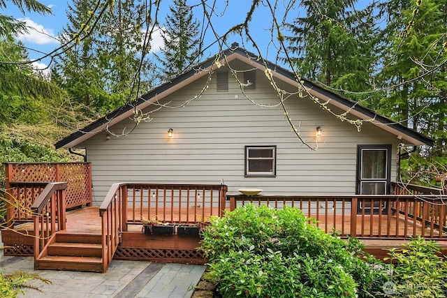 back of property with a wooden deck