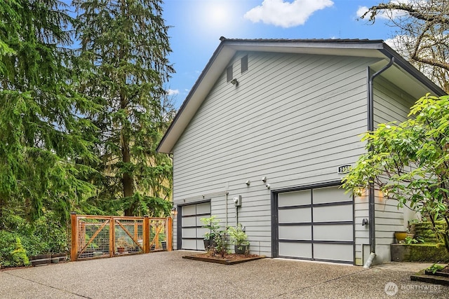 view of home's exterior featuring an attached garage and driveway