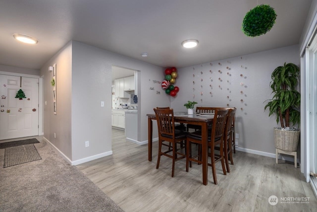 dining space with light hardwood / wood-style floors