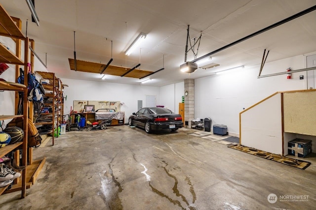 garage featuring a garage door opener and a workshop area