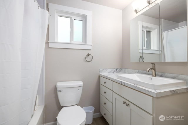 full bathroom with vanity, shower / bathtub combination with curtain, and toilet