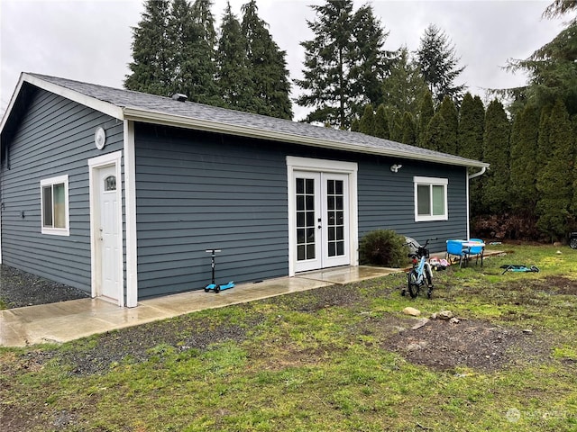 back of house with a lawn and french doors