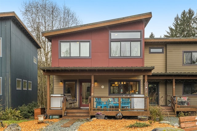 rear view of house featuring a porch