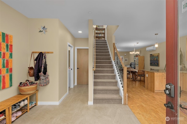 interior space with an inviting chandelier and a wall mounted air conditioner