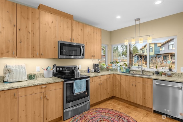 kitchen with stainless steel appliances, light stone countertops, sink, and light brown cabinets