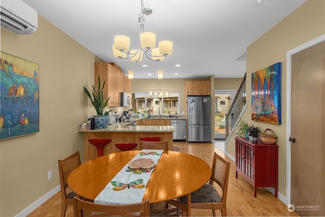 dining space with a chandelier and a wall unit AC