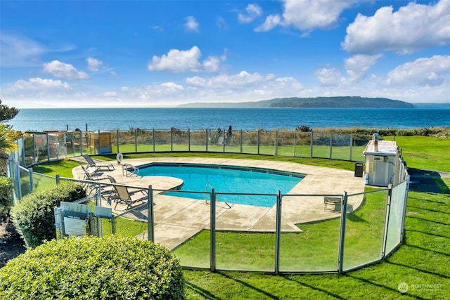 view of swimming pool with a water and mountain view, a yard, and a patio