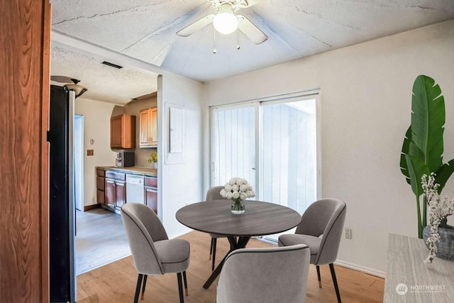 dining area featuring light hardwood / wood-style flooring and ceiling fan