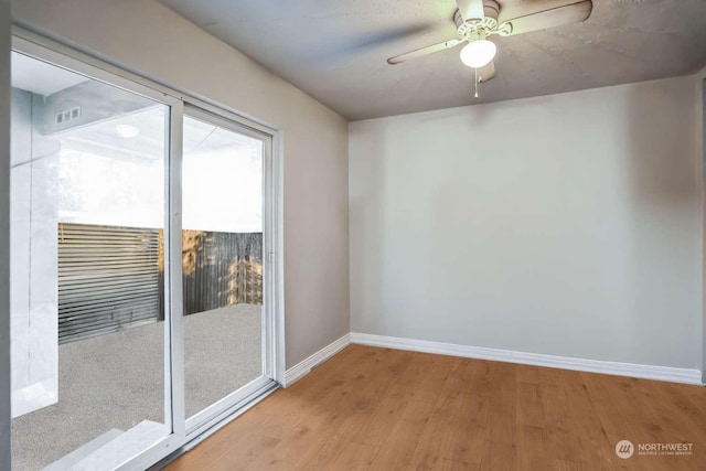 spare room with light hardwood / wood-style flooring and ceiling fan