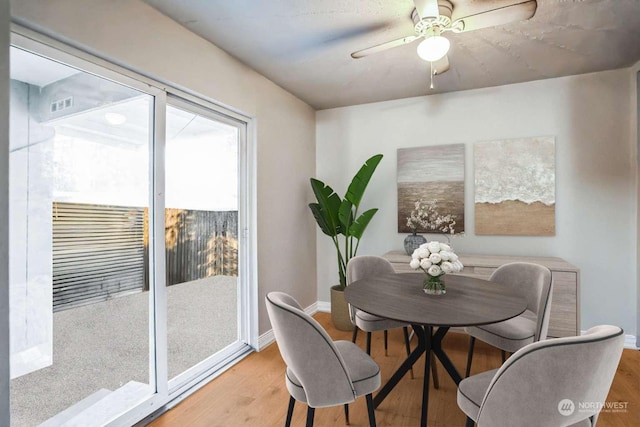 dining space featuring ceiling fan and light hardwood / wood-style flooring